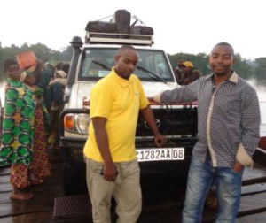 Jeep with medicines on ferry crossing Lulua River.